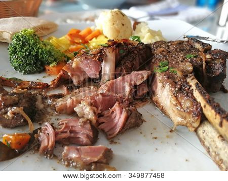 Cut Pieces Of Meat On The Bone. Kleftiko Dish Cuisine Of Cyprus. Stewed Lamb Meat Served With Vegeta