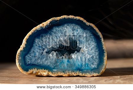Geode With Transparent Crystals Of Light-blue Color On A Dark Background.
