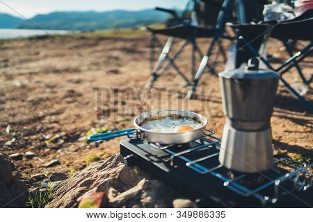 Person Cooking Fried Eggs Hot Drink In Nature Camping Outdoor, Cooker Prepare Scrambled Omelette Bre