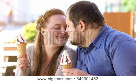 Romantic Couple Nuzzling Holding Sweet Ice-cream In Hands, Diabetes Risk