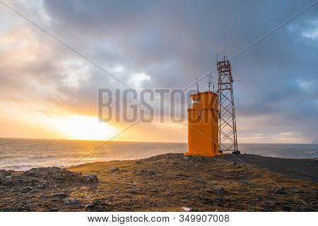 The Lighthouse Of Hvalnes In East Iceland With The Atlantic Ocean In The Background