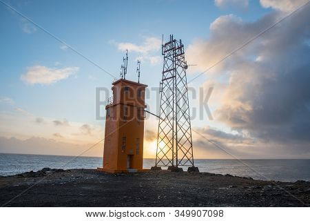 The Lighthouse Of Hvalnes In East Iceland With The Atlantic Ocean In The Background