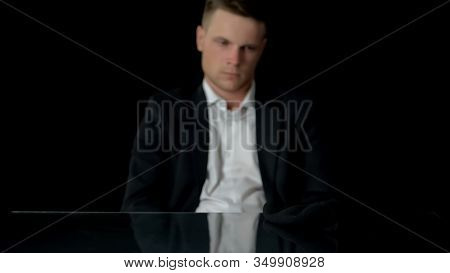 Man In Suit Looking At Balaclava, Preparing To Commit Crime, Doubtfulness
