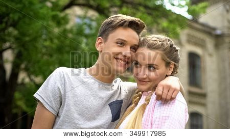 Couple Of Shy Happy Teenagers Embracing, First Relationship, Studentship