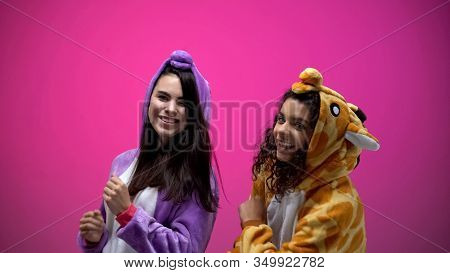 Female Friends In Unicorn And Giraffe Pajamas Dancing, Carnival Party, Fun Time
