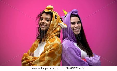 Two Interracial Women In Funny Pajamas Standing Back To Back With Hands Crossed