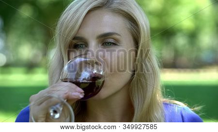 Closeup Of Beautiful Woman Drinking Wine In City Park, Spending Leisure Time