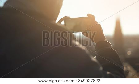 Male Tourist Taking Shot Of Old European City Center, Aerial View From Skydeck