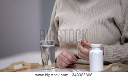 Aged Woman Taking Pills, Suffering From Incurable Disease, Rehabilitation Center
