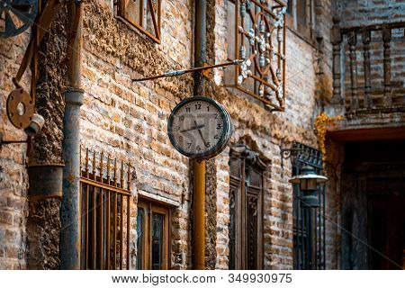 Gonzalez Catan, Argentina, September 28, 2019: Very Old Watch Hanging From A Brick Wall Of Abandoned