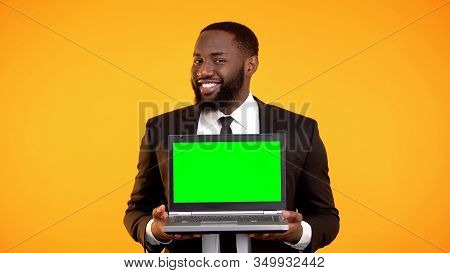 African-american Businessman Holding Prekeyed Laptop And Smiling, Ad Template