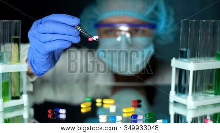 Lab Assistance Comparing Different Pills Samples, Pharmaceutical Production
