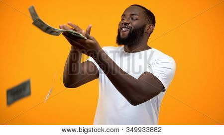 Happy African-american Man Throwing Dollars Banknotes, Wasting Money, Concept