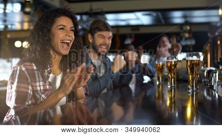 Attractive Lady And Male Friends Celebrating Team Winning Game, Time In Pub