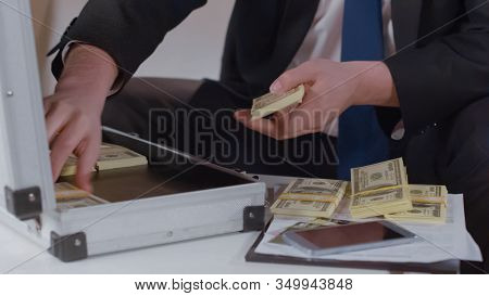 Closeup Of Entrepreneur Counting Money From Briefcase, Kickback In Business