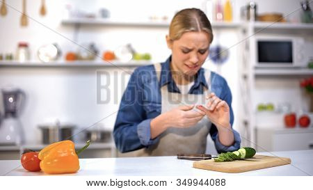 Female Cut Finger While Slicing Cucumber, Accident In Kitchen, Household Injury