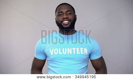 Smiling African-american Volunteer In Blue T-shirt Looking At Camera, Help