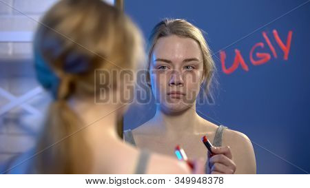 Depressed Girl Looking In Mirror, Word Ugly Written By Lipstick, Insecurities