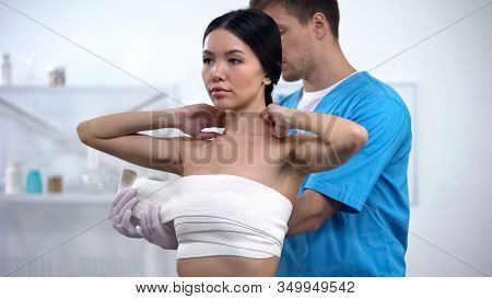 Male Plastic Surgeon Applying Elasto-fit Breast Female Patient, Compression