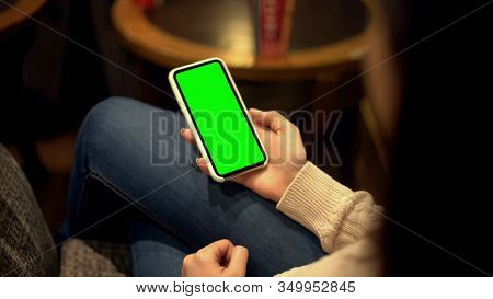 Woman Holding Smartphone With Green Screen, Place For Ad, Alpha Channel Template