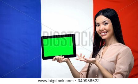 Girl Holding Tablet With Green Screen, France Flag On Background, Migration