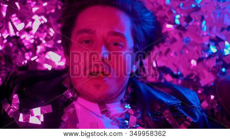 Guy Taking Ecstasy Blotter To Have Fun At Party, Lying On Floor, Drug Addiction