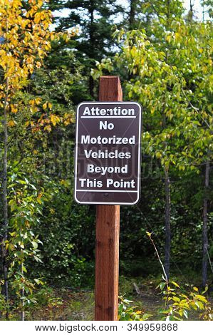 An Attention No Motorized Vehciles Beyond This Point Sign