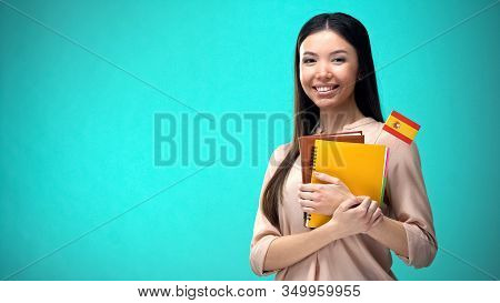Cheerful Woman Holding Spanish Flag Book, Education Abroad, Learning Language