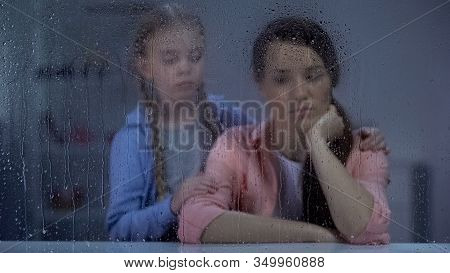 Daughter Supporting Mother Behind Rainy Weather, Incurable Disease Concept