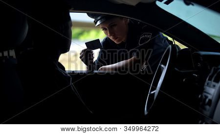 Police Woman Checking Documents Of Driver, Inspection On Road, Traffic Offence