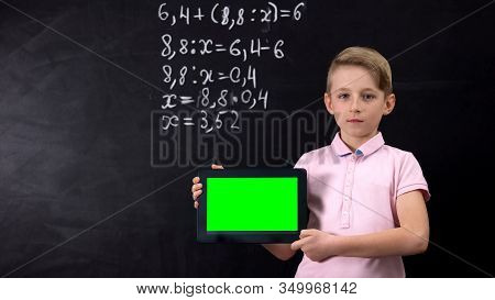 Schoolboy Holding Tablet With Green Screen, Application For Learning Math