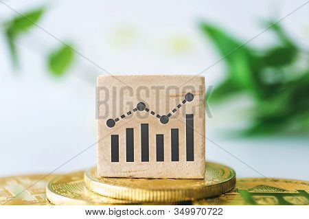 Graph Rising Up Growht Exponencial Sign On Wooden Cube With Objects Such As Gold Coin, Calculator An