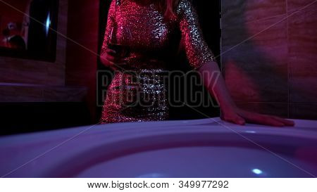 Drunk Woman With Glass Of Wine Feeling Bad In Night Club Bath-room, Overdrinking