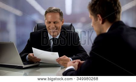 Smiling Boss Reading Curriculum Vitae Of Employee, Appropriate Candidate
