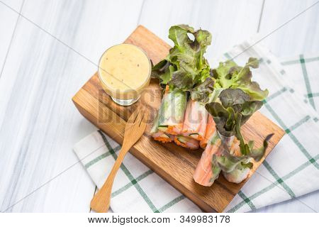 Fresh Vegetable And Crab Stricks Salad Roll Wrap With Noodle On Wood Plate On Tablecloths On White W