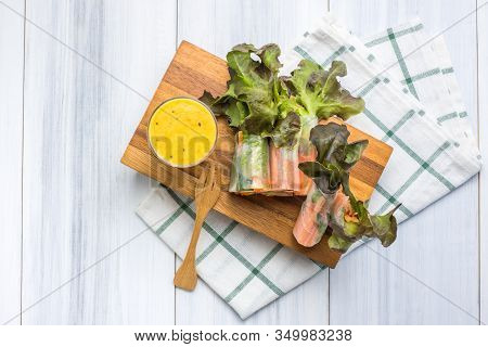 Fresh Vegetable And Crab Stricks Salad Roll Wrap With Noodle On Wood Plate On Tablecloths On White W