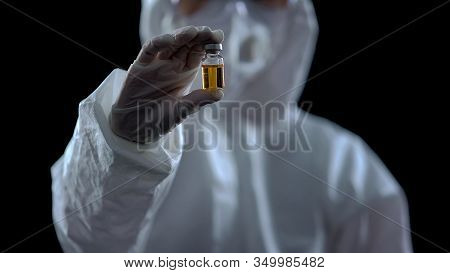Epidemiologist Showing Bottle With Yellow Liquid, Vaccine Development, Treatment