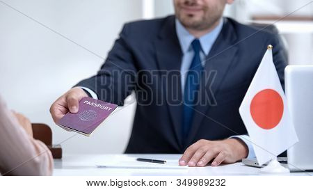 Consular Officer Of Japan Giving Passport To Woman, Approved Tourist Visa