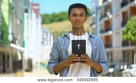 Teen Male Christian Holding Holy Bible Near Heart, Faith And Belief, Religion
