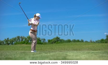 Woman Performing Backswing Position Hitting Ball On Course Sport Training, Hobby