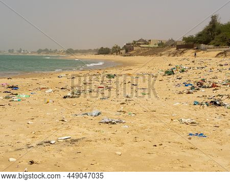 Warang, Mbour, Senegal - Circa January 20222. Beach Sand Of Atlantic Ocean With So Many Garbage Plas