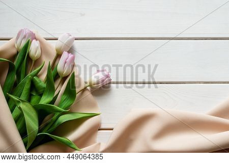 Spring Bouquet Of Pink Tulips On Beige Cloth On Wooden Background
