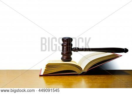 Abstract Photo With Wooden Gavel And Book With Codes On White Background As Symbol Of Of Rule Of Law
