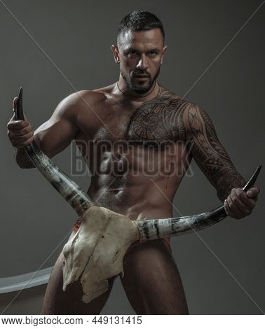 Treason. Brutal Men With Horns. Treason And Resentment. Resentment Of Bearded Man After Treason With