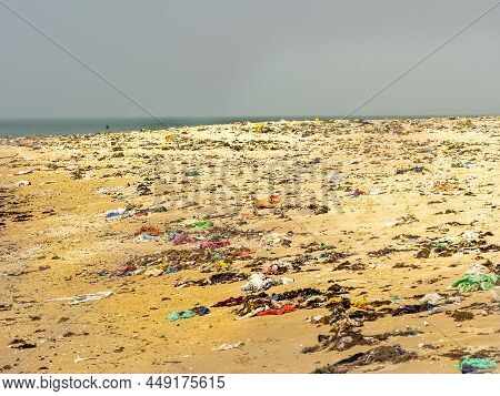 Warang, Mbour, Senegal - Circa January 20222. Beach Sand Of Atlantic Ocean With So Many Garbage Plas