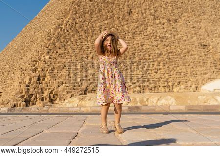 Cute Little Girl Dancing In Front Of The Cheops Pyramid On The Giza Plateau