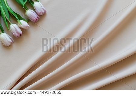 Spring Bouquet Of Pink Tulips On Beige Fabric With Folds