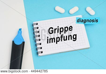 Medicine And Health Concept. On A White And Blue Surface Are Pills, A Marker And A Notebook With The
