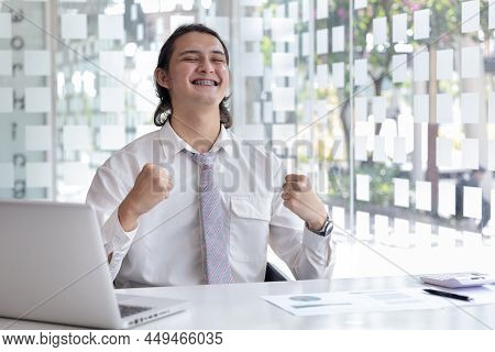 Joyful, Surprised Or Shocked Asian Man Raised Her Arms All The Way Because She Is Very Happy The Bos