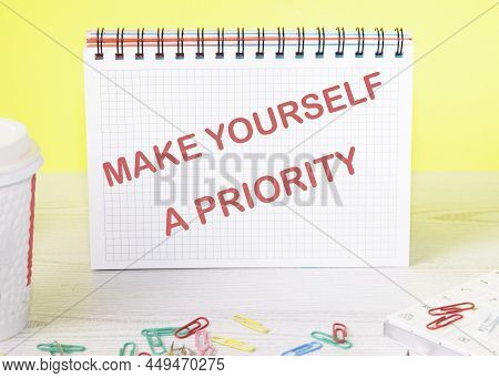 Make Yourself A Priority Text On A Notebook Standing On A Table On A Yellow Background.